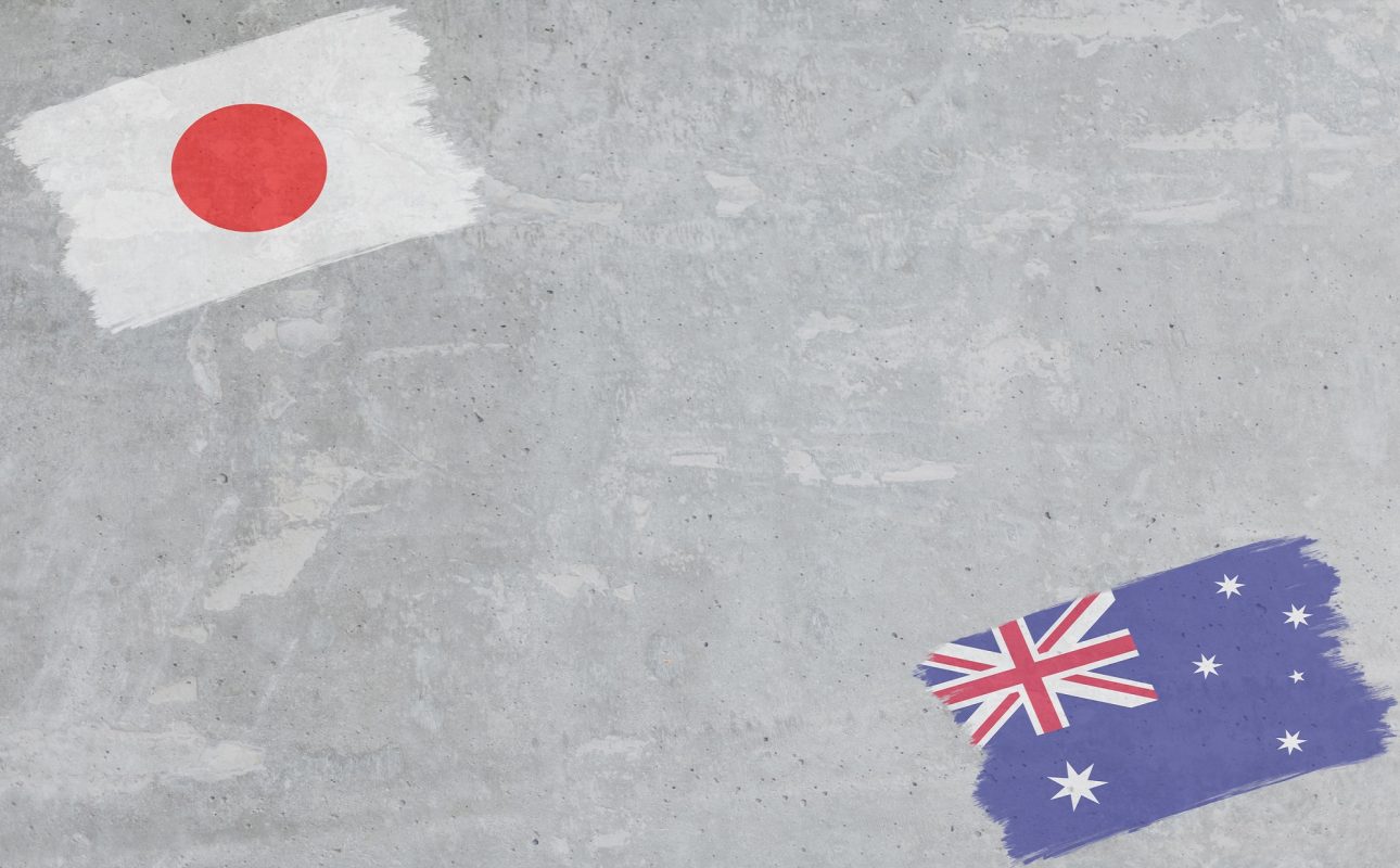 Concrete wall painted with Japan and Australia flags with a dry brush