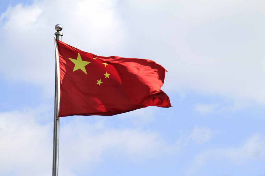 Chinese flag waving in the wind on a sunny day