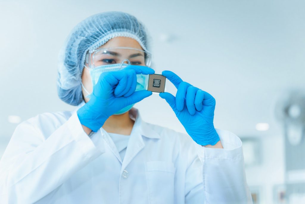 Portrait of electronics engineer is holding CPU's computer for examination